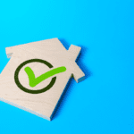 The picture shows an illustration of a house and a green tick, which indicates property verification.